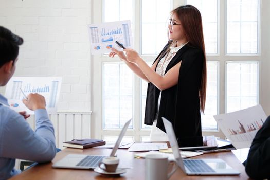 executive businesswoman advising analyzing discussing business project with co-worker team