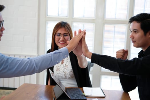 business people joining united hand, business team touching hands together after complete a deal in meeting. unity teamwork partnership corporate concept.