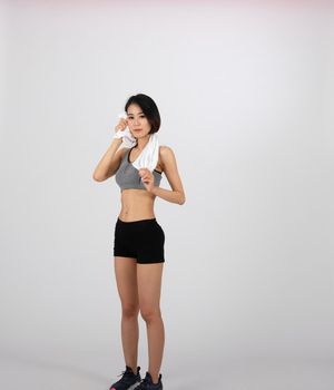 sporty fitness woman in sportswear with towel on white background. healthy sport lifestyle