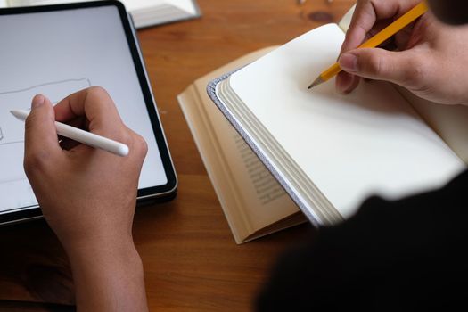 designer working on graphic tablet discussing creative idea of startup project with partner