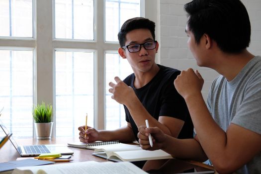 designer working on graphic tablet discussing creative idea of startup project with partner