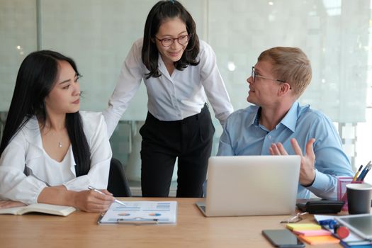 business people discussing on performance revenue in meeting. businessman working with co-worker team. financial adviser analyzing data with investor.