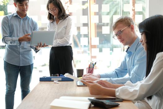 business people discussing on performance revenue in meeting. businessman working with co-worker team. financial adviser analyzing data with investor.