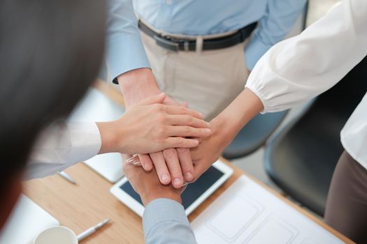 businessman businesswoman joining united hand, business team touching hands together after complete a deal in meeting. unity teamwork partnership corporate concept.