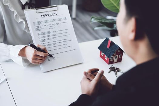 Guarantee, Mortgage, agreement, contract, Signing, Male client holding pen to reading agreement document to sign land loan with real estate agent or bank officer