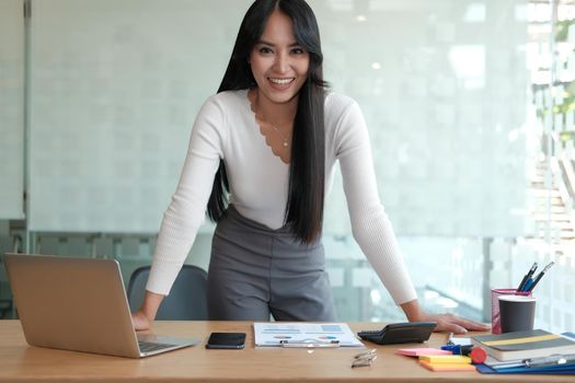 young confident asian executive businesswoman woman smiling at business workplace