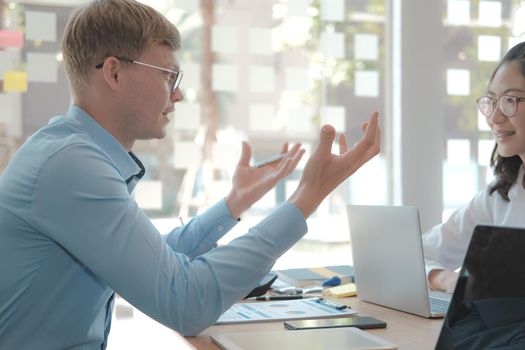 business people discussing on performance revenue in meeting. businessman working with co-worker team. financial adviser analyzing data with investor.