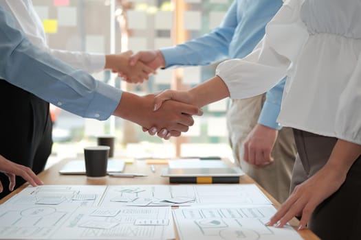 businessman shaking hands with businesswoman after UI UX desiner meeting. Business people handshaking. Greeting deal, teamwork partnership concept.