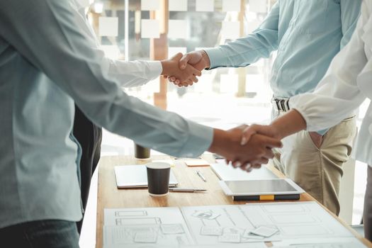 businessman shaking hands with businesswoman after UI UX desiner meeting. Business people handshaking. Greeting deal, teamwork partnership concept.