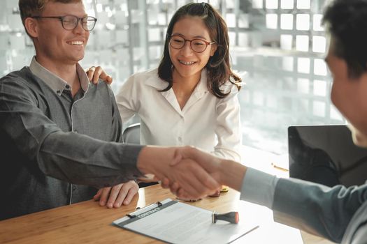 couple customer shaking hands with insurance mortgage broker lawyer realtor. client handshaking financial advisor bank worker making sale purchase deal