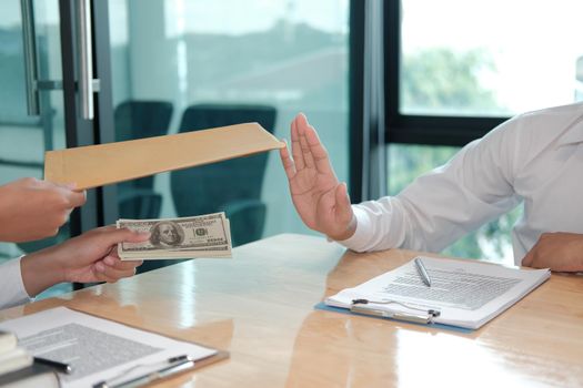 businessman rejecting money cash banknote from woman.  honest man refuse to take the bribe. anti bribery, corruption, venality concept.