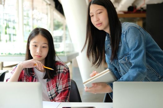 girl teenager studying with computer laptop. college high school student taking note