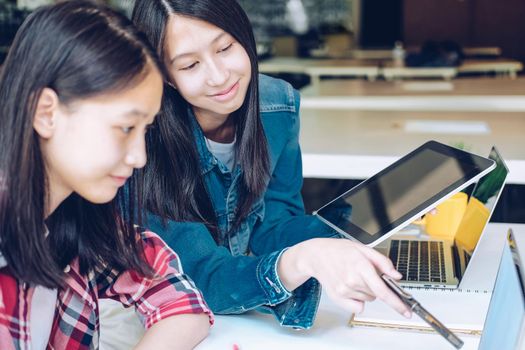 girl teenager college high school student studying with tablet computer laptop