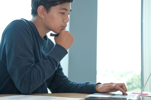 startup male freelancer working with computer at office. man entrepreneur analyzing financial performance at workplace. student studying doing assignment