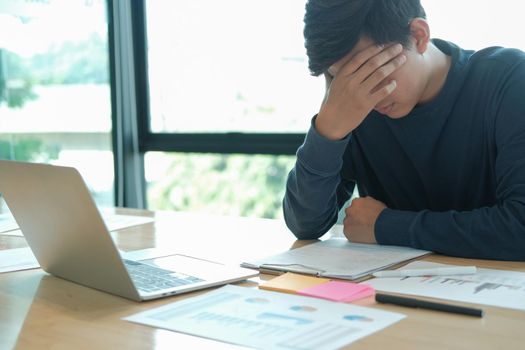 man feeling tired, frustrated & stressed from hard work. exhausted freelancer have headache at workplace.