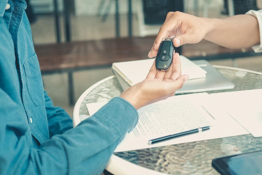 salesman dealer giving car key to new owner. car sale & dealership in auto business