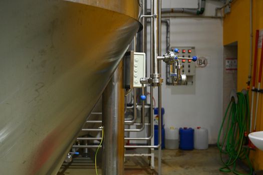 Cistern with metal tap. Beer production.