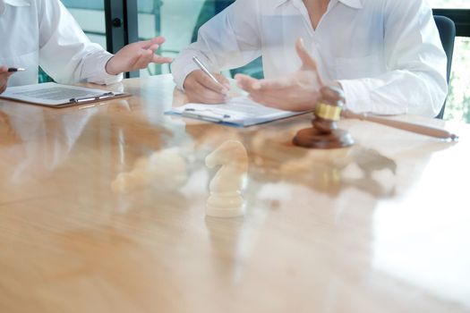 lawyer giving advice to a man. businessman discussing legal legislation at law firm. judge team meeting at courtroom