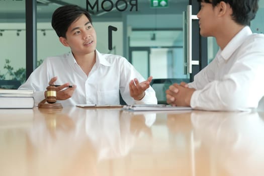 lawyer giving advice to a man. businessman discussing legal legislation at law firm. judge team meeting at courtroom