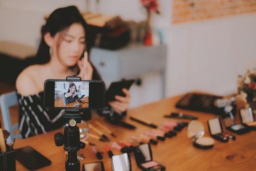 beauty blogger live broadcasting cosmetic makeup tutorial on social media. vlogger recording vlog video. influencer marketing