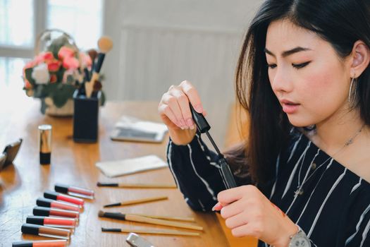 asian woman applying makeup cosmetic. make up beauty concept