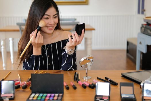asian woman applying makeup cosmetic. make up beauty concept