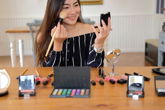 asian woman applying makeup cosmetic. make up beauty concept