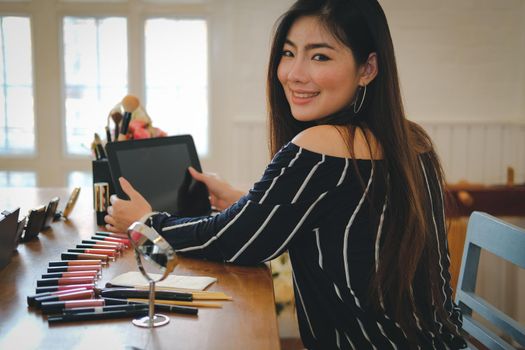 asian woman applying makeup cosmetic. make up beauty concept