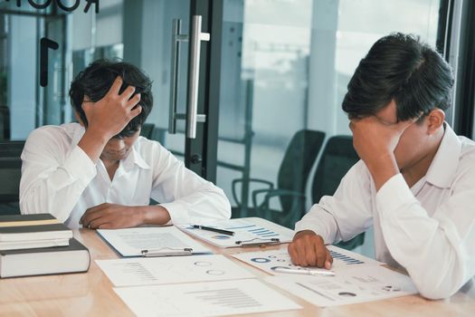 man feeling tired, frustrated stressed from hard work. exhausted businessman have headache at workplace.