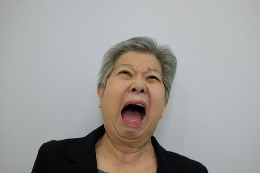 scared elder woman. frightened elderly female. surprised asian senior