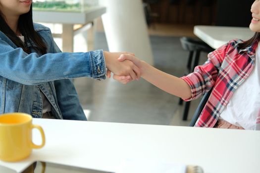 asian girl teenager friends shaking hands for startup project. teamwork, friendship concept