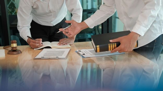 lawyer giving advice to a man. businessman discussing legal legislation at law firm. judge team meeting at courtroom