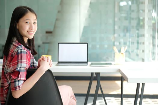 asian teenage girl teenager posing at co-working space