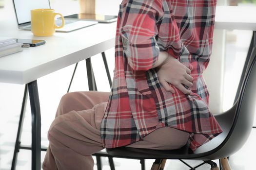 girl woman touching back with hurt pain suffering from backache at workplace