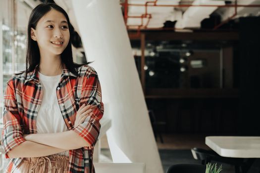 asian teenage girl teenager posing at co-working space