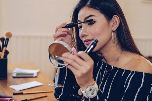 asian woman applying makeup cosmetic. make up beauty concept