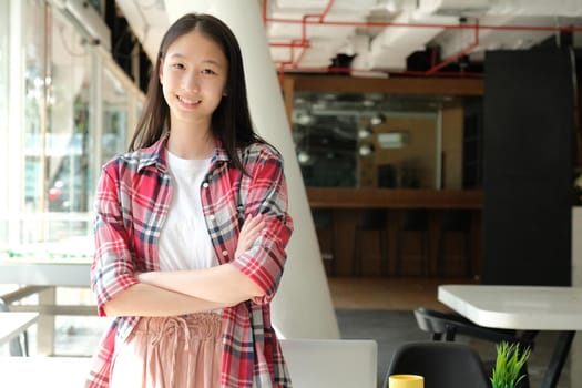 asian teenage girl teenager posing at co-working space