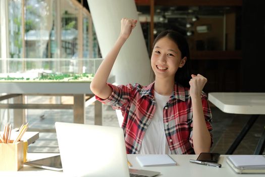 happy asian woman girl teenager raising hands with gladness happiness