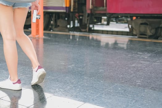 young asian woman  backpacker traveler with camera backpack at train station. journey trip travel concept