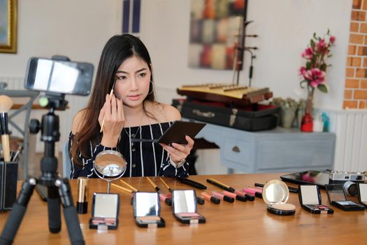 beauty blogger live broadcasting cosmetic makeup tutorial on social media. vlogger recording vlog video. influencer marketing