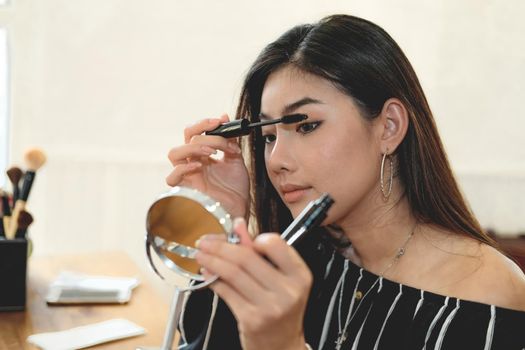 asian woman applying makeup cosmetic. make up beauty concept