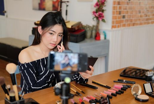 beauty blogger live broadcasting cosmetic makeup tutorial on social media. vlogger recording vlog video. influencer marketing