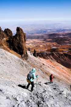 Tourists trekking on Erciac volcano in Turkey, view from top