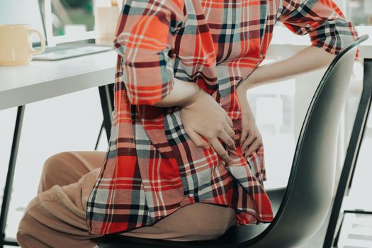 girl woman touching back with hurt pain suffering from backache at workplace