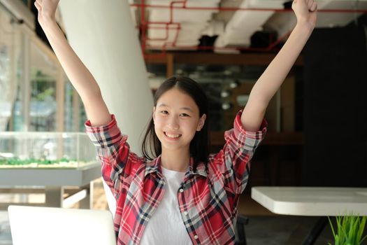 happy asian woman girl teenager raising hands with gladness happiness