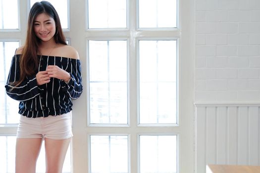 young asian woman in casual clothing posing at home