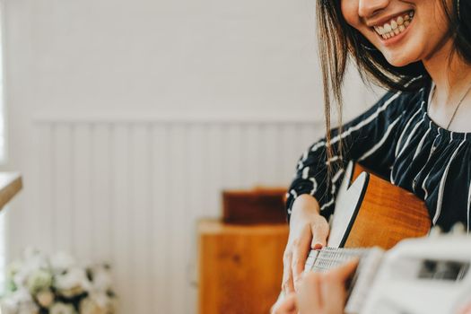 woman playing guitar at home.  leisure lifestyle concept