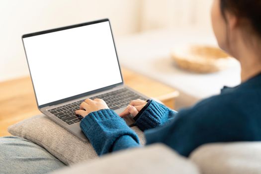 Close up hand of Young Asian woman using social media by laptop. Lifestyle ,Shopping online, relax on sofa