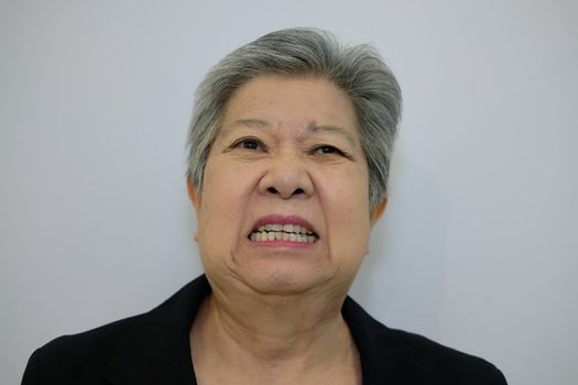 furious elder woman, enraged elderly female. angry asian senior