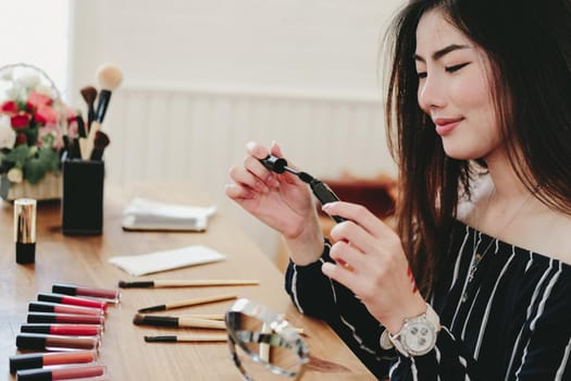 asian woman applying makeup cosmetic. make up beauty concept